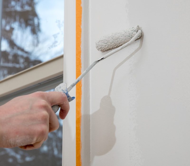 painting-apartment-renovating-with-white-color-paint-roller-room-min